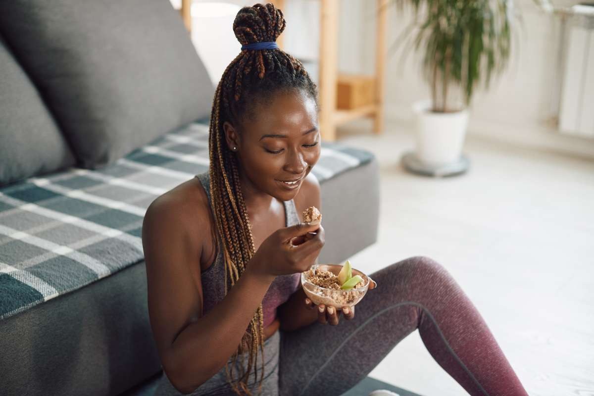 An athletic woman enjoys a healthy meal after a Pilates class